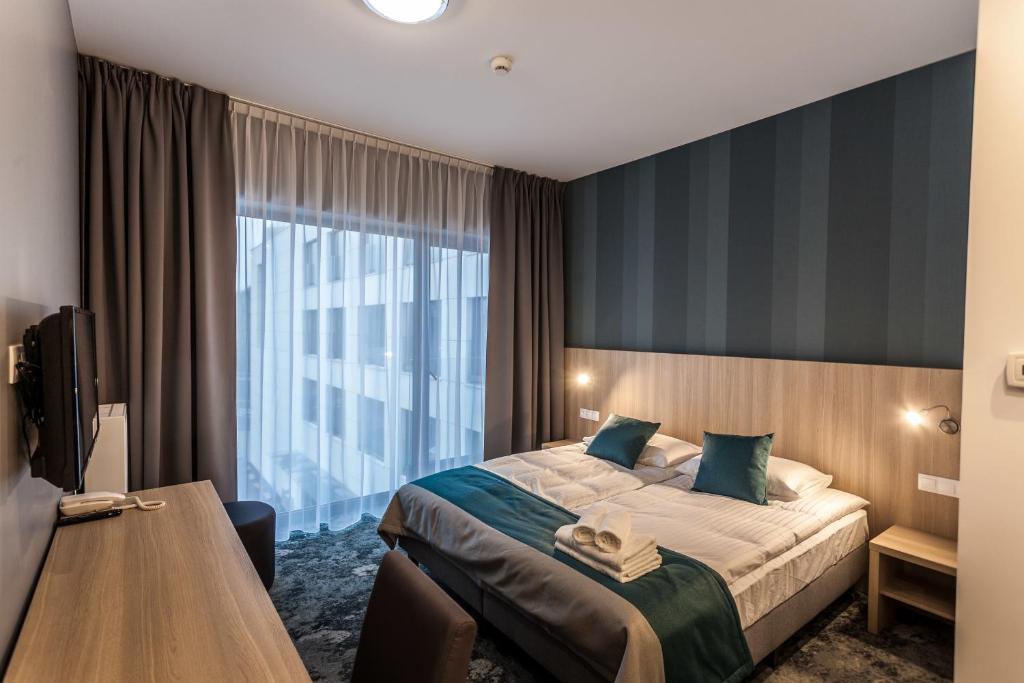 Postel nebo postele na pokoji v ubytování Hotel Zatoka