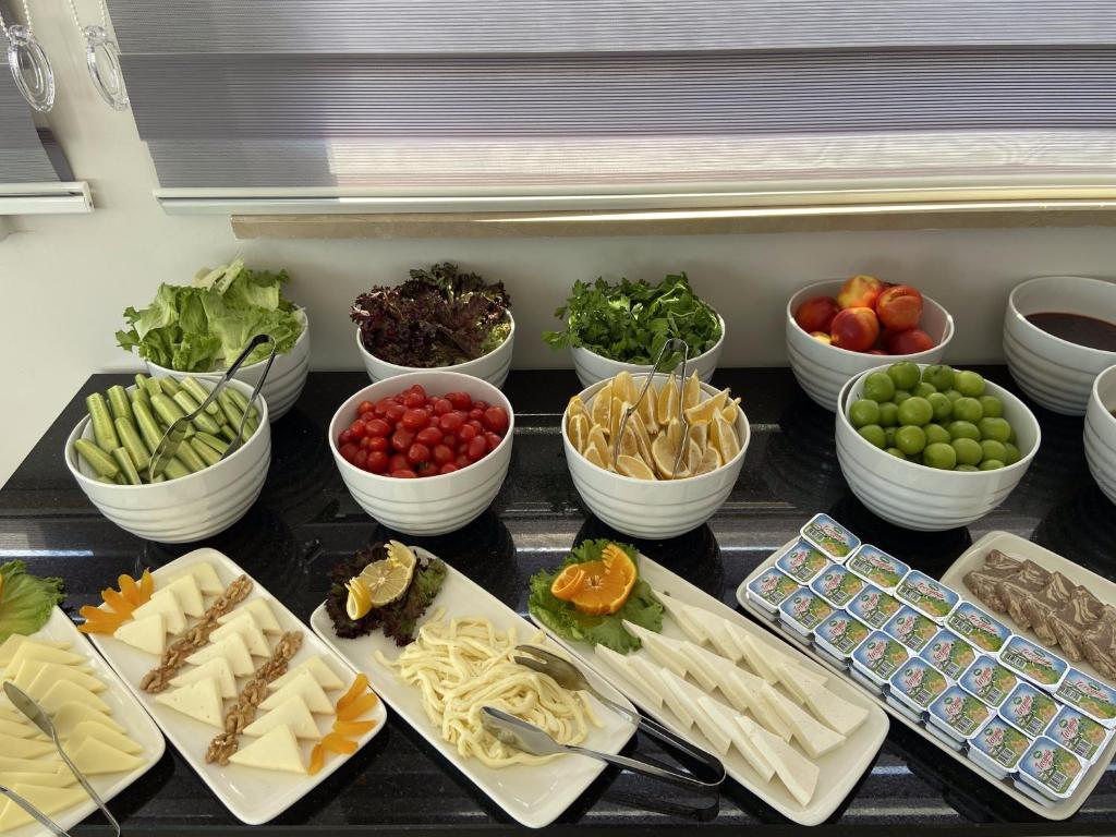 a table topped with bowls of different types of food at JK BUSINESS HOTEL in Denizli