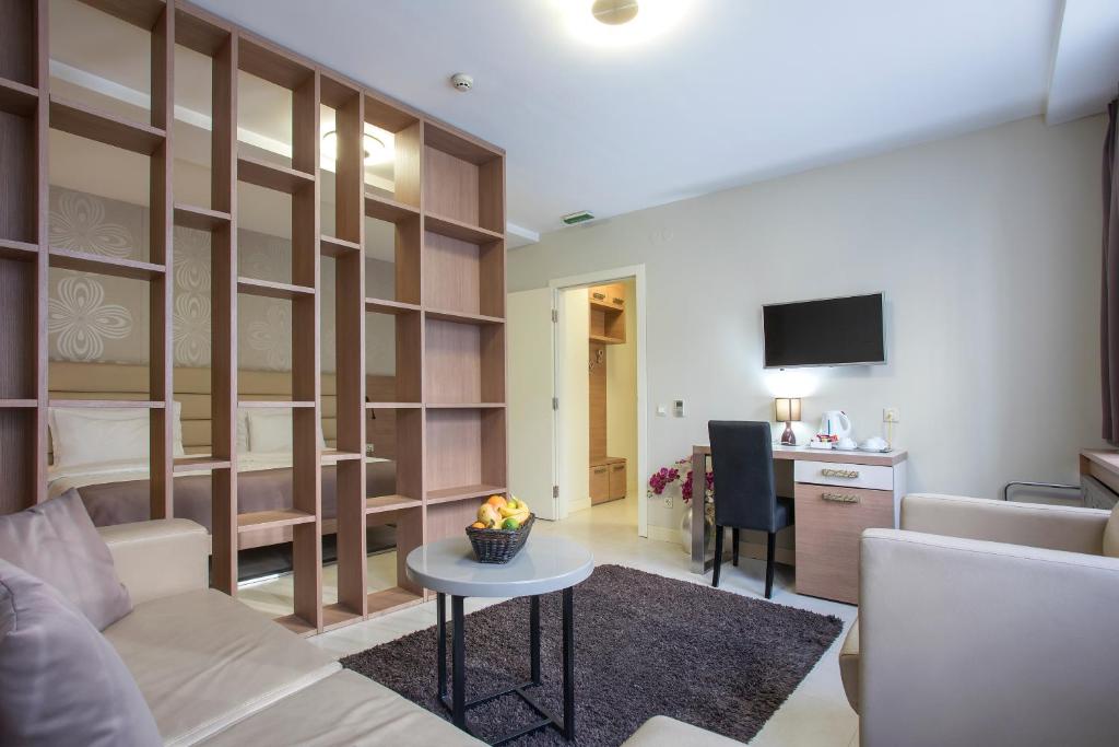 a living room with a couch and a table at Hotel Srbija Garden-FREE PARKING in Belgrade