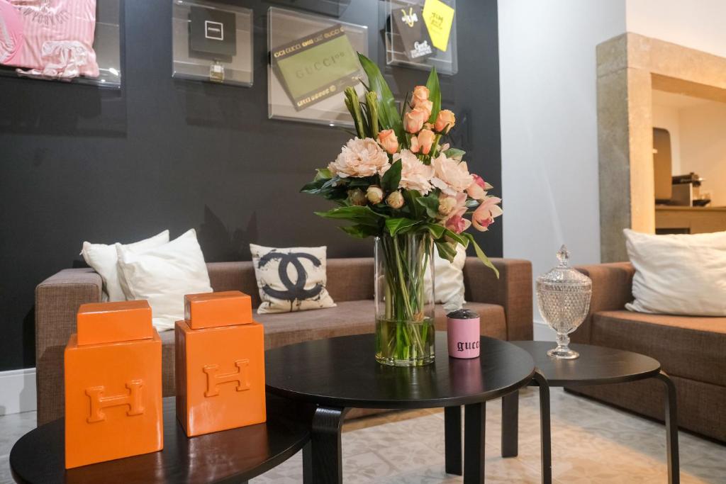 a vase of flowers on a table in a living room at RM The Experience - Small Portuguese Hotels in Setúbal