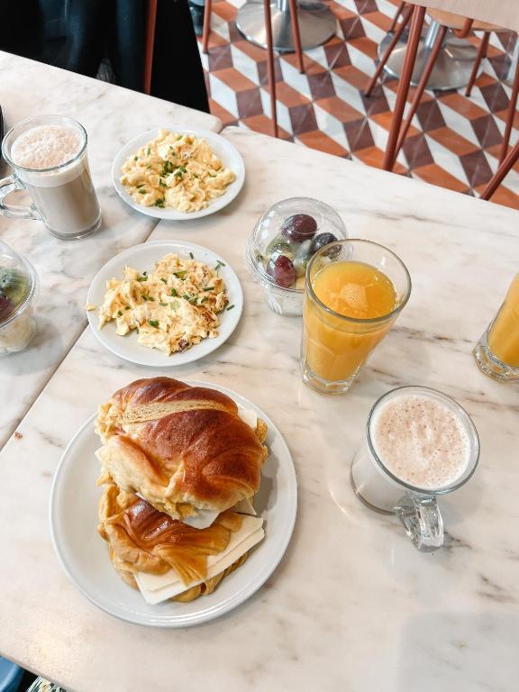 a table with plates of food and drinks on it at RM The Experience - Small Portuguese Hotels in Setúbal