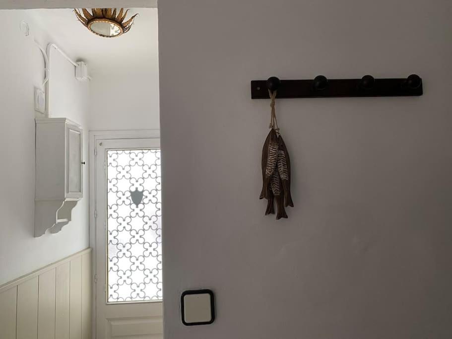 a hanging item on a wall next to a window at Casita pueblo al lado Del Mar-Vilasardemarlux4 in Vilassar de Mar