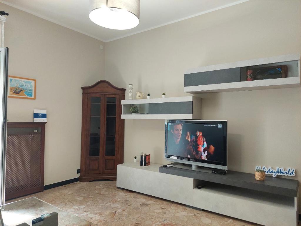 a living room with a flat screen tv on a entertainment center at House Mamma Marisa by Holiday World in Genoa