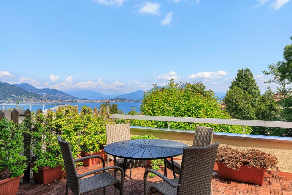 a patio with a table and chairs and a view of the water at Maravilla - By Impero House in Baveno