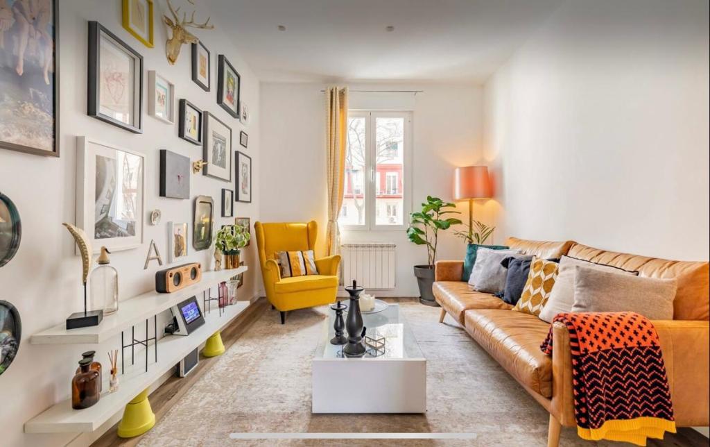 a living room with a couch and a yellow chair at Habitación Simple en PISO COMPARTIDO C in Madrid