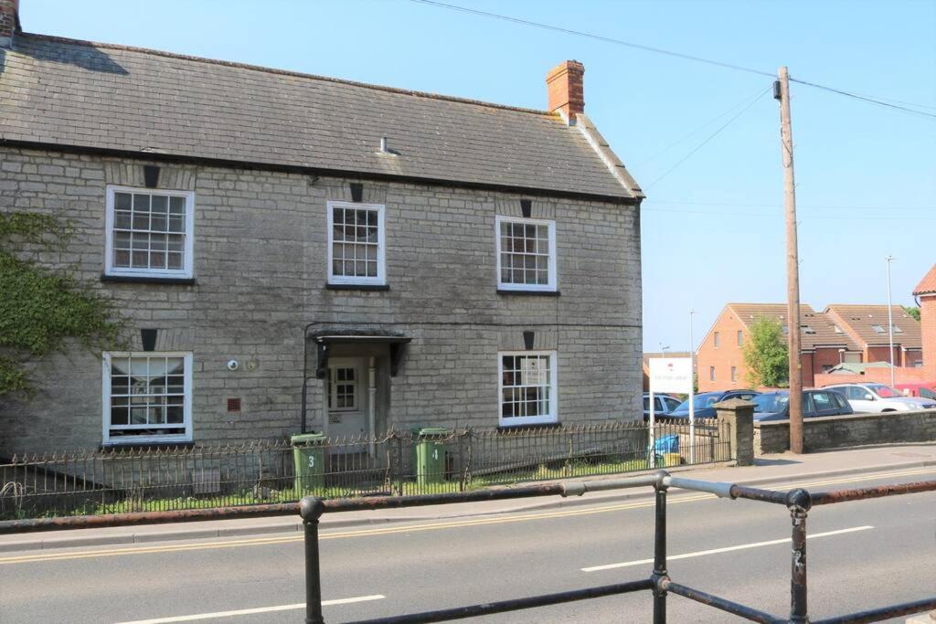 an old brick house on the side of a street at Flat 2 @ 28 Chilkwell Street in Glastonbury