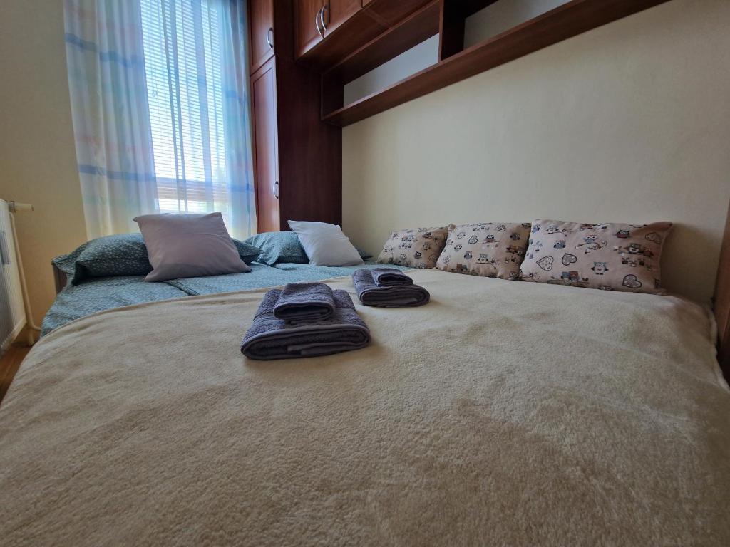 a bedroom with a bed with two towels on it at Casa Cristina in Pécs