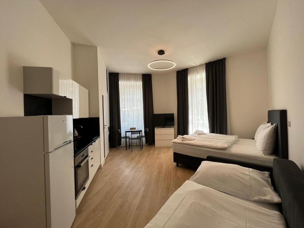 Postel nebo postele na pokoji v ubytování Figaro Suites