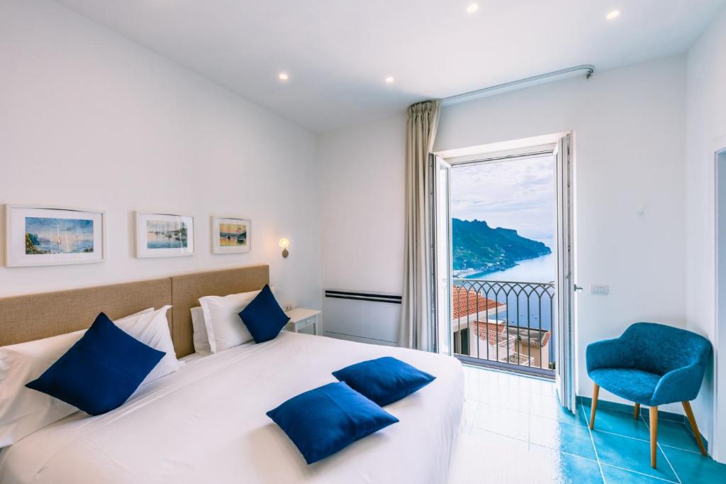 ein Schlafzimmer mit einem großen Bett und einem großen Fenster in der Unterkunft Casa Dolce Casa in Ravello