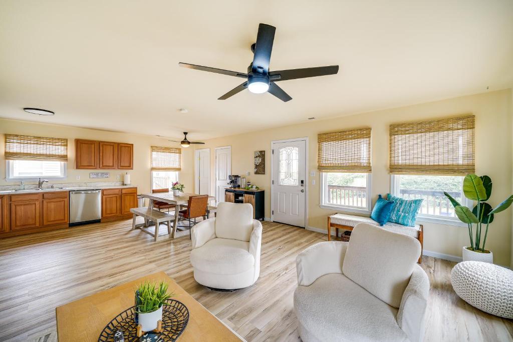 a living room with white furniture and a ceiling fan at Nags Head Vacation Rental with Hot Tub Near Beach! in Nags Head