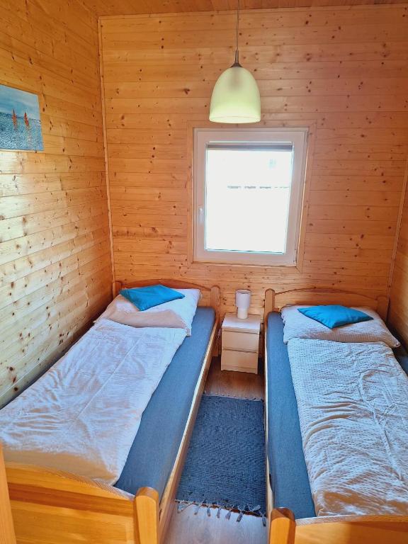 Postel nebo postele na pokoji v ubytování MożeMorze? Ośrodek Domków Letniskowych