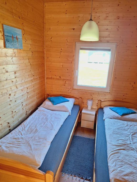 Postel nebo postele na pokoji v ubytování MożeMorze? Ośrodek Domków Letniskowych