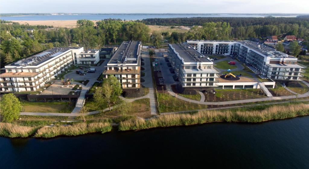 an aerial view of a building next to the water at Blue Sea Apartment & SPA 8/2 in Dziwnów