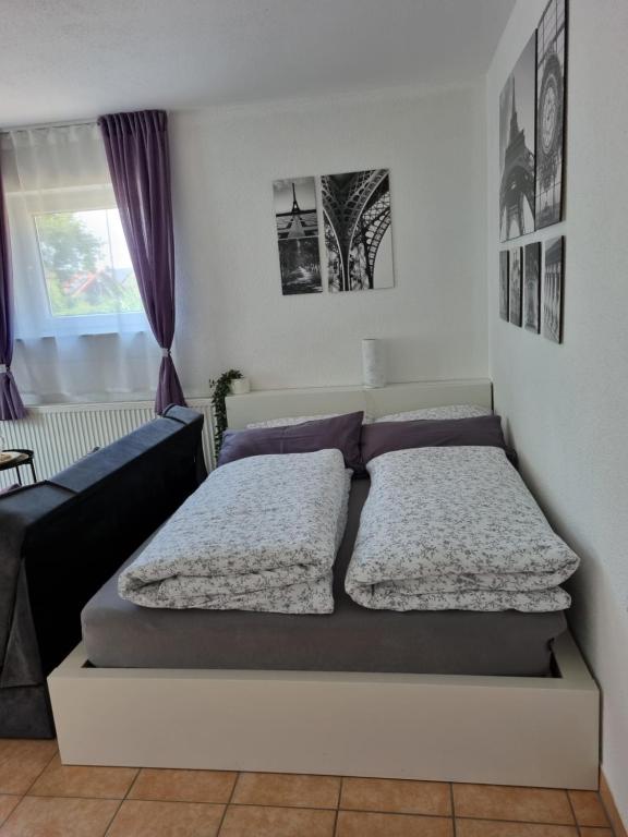 a bedroom with two beds and a couch at Tauberperle in Weikersheim