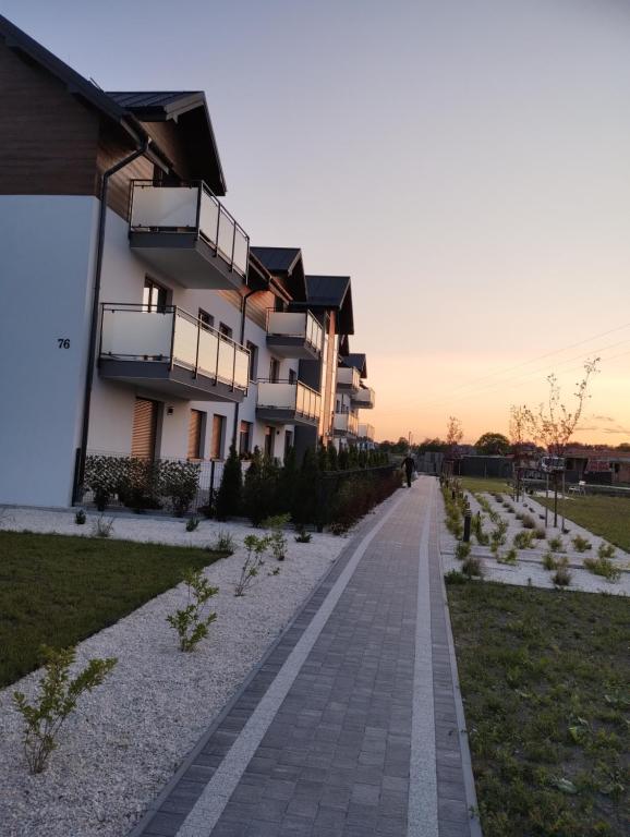 a building with balconies on the side of a road at Apartament Emilia in Busko-Zdrój