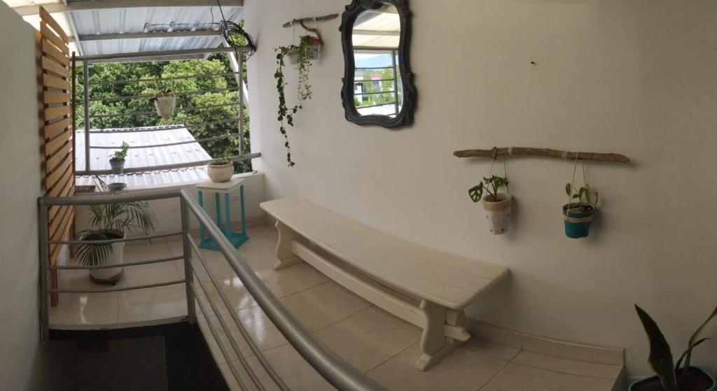 a stairway with a bench and plants in a room at APARTAESTUDIO SENDERO PRIMAVERA 2 in Neiva