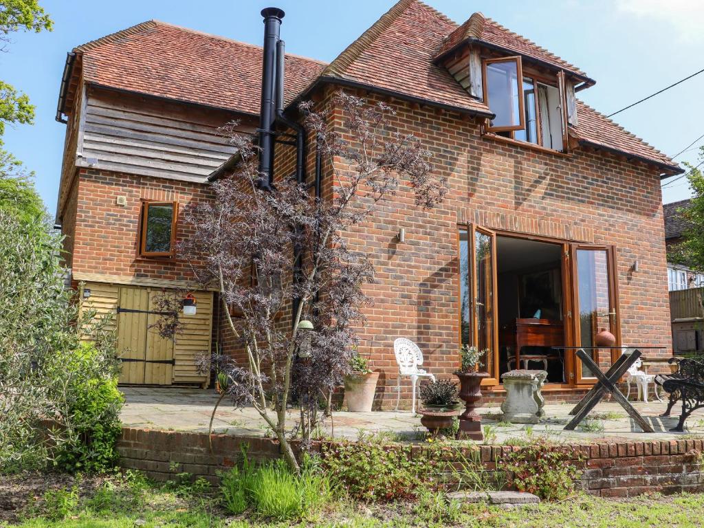a brick house with a front door and a window at Six Acres House in Rye