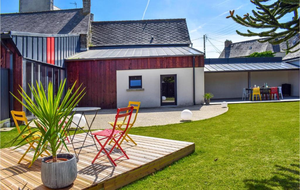 a deck with chairs and a table in a yard at Amazing Home In Le Vieux-bourg With Private Swimming Pool, Can Be Inside Or Outside in Le Vieux-Bourg