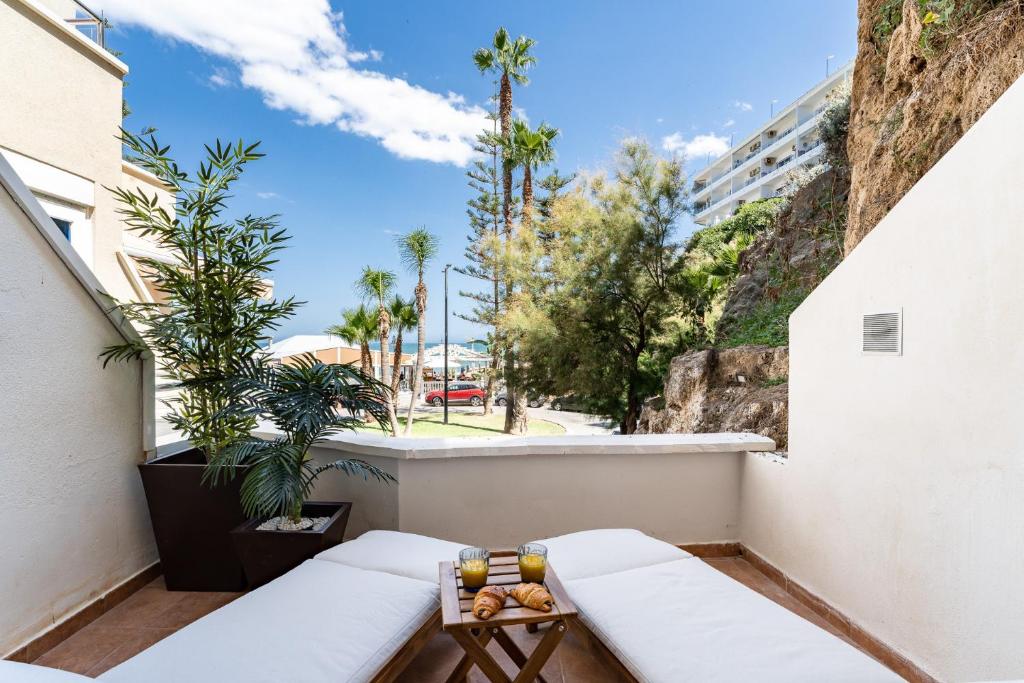 balkon z ławką i widokiem na ulicę w obiekcie Luxury Beachfront Living on the beach with big terrace w mieście Torremolinos