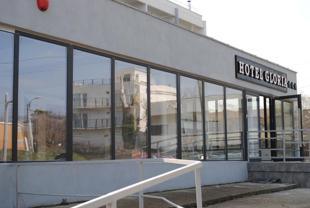 a building with a lot of glass windows at Hotel Gloria in Eforie Sud