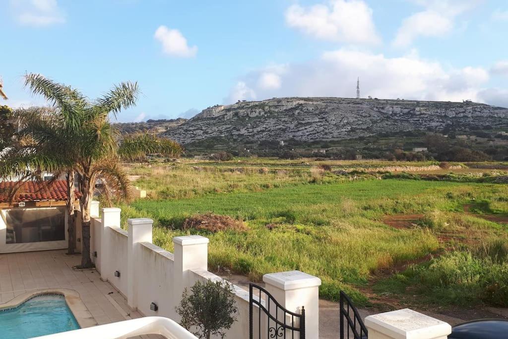 a house with a view of a hill at Spacious, modern apartment near beach andclose to st. Julians in Naxxar