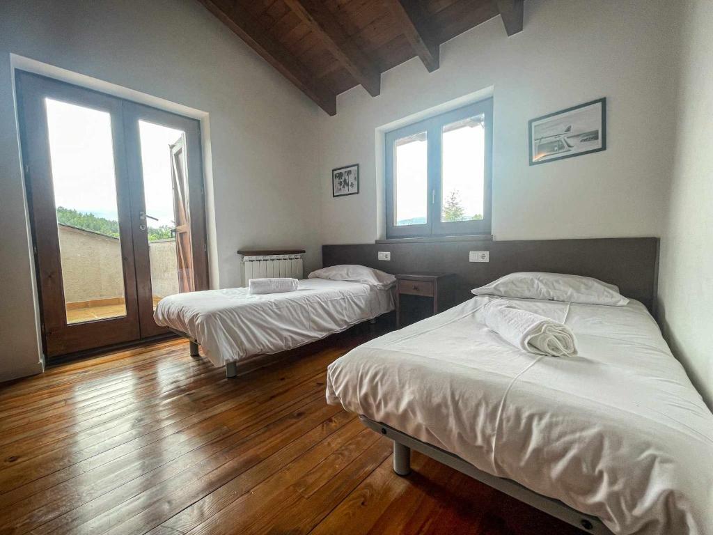 Posteľ alebo postele v izbe v ubytovaní Cal Peró Casa de montaña