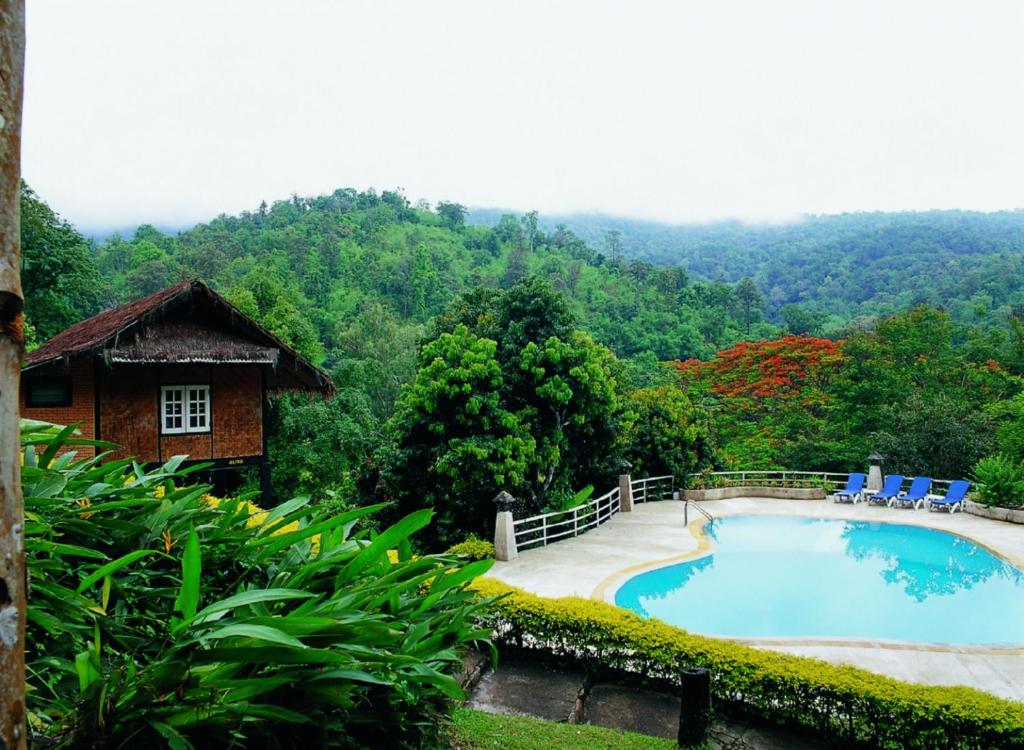 a swimming pool in the middle of a forest at Mae Sa Valley Garden Resort in Ban Mae Mae