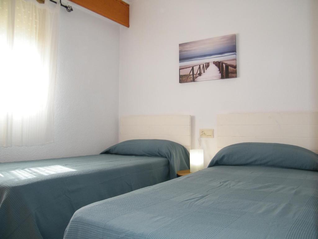 Postel nebo postele na pokoji v ubytování JARDÍN VI Mnostrum Playa de Gandía