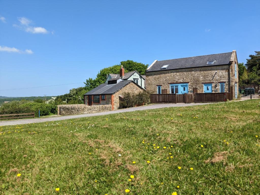 a house with a grassy field in front of it at The Linhay in Bridport