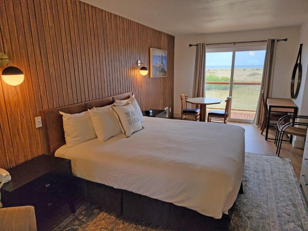 a hotel room with a bed and a table with chairs at Chautauqua Resort & Conference Center in Long Beach