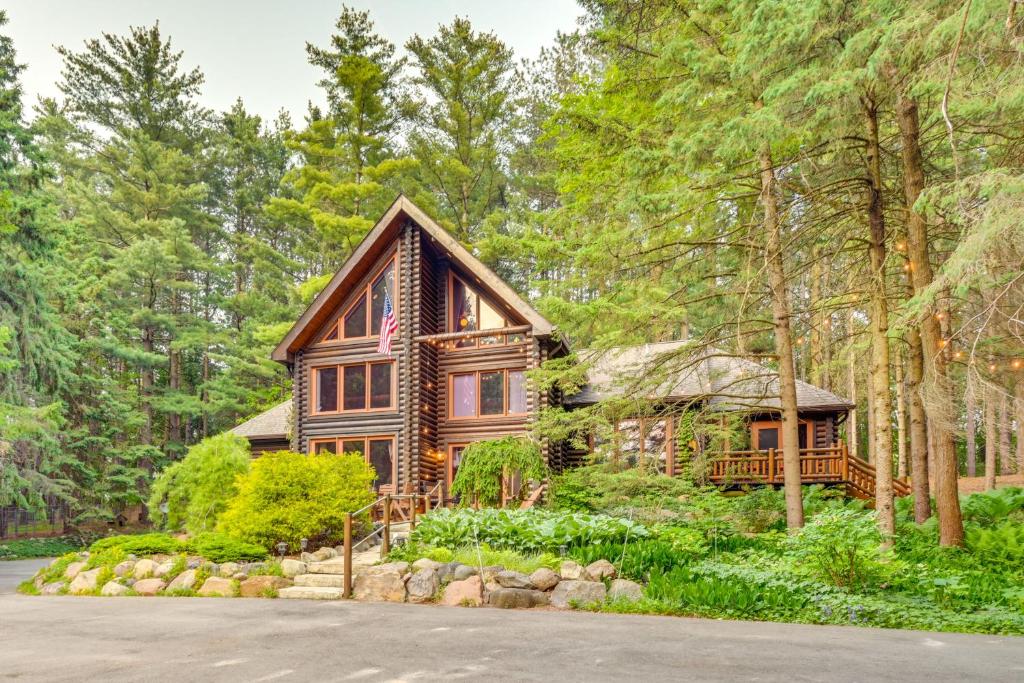 a log cabin in the woods with a driveway at Magical Metamora Cottage with Fire Pit, Pond, Deck! in Metamora