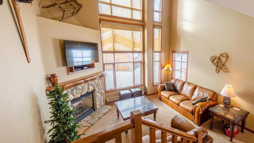 a living room with a couch and a fireplace at Trails Edge #03 By Bear Country in Sun Peaks