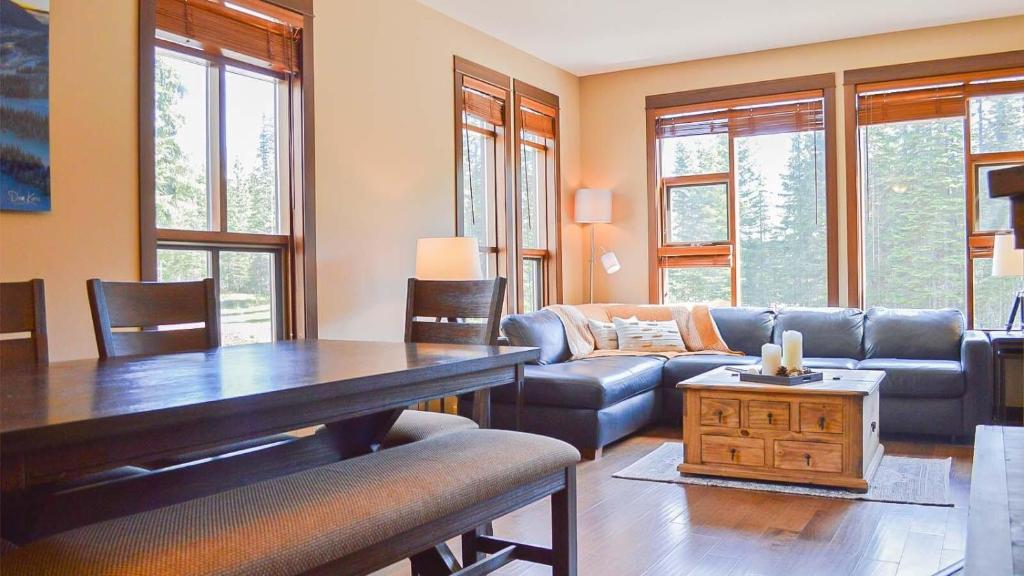 a living room with a couch and a table at Stones Throw #24 in Sun Peaks