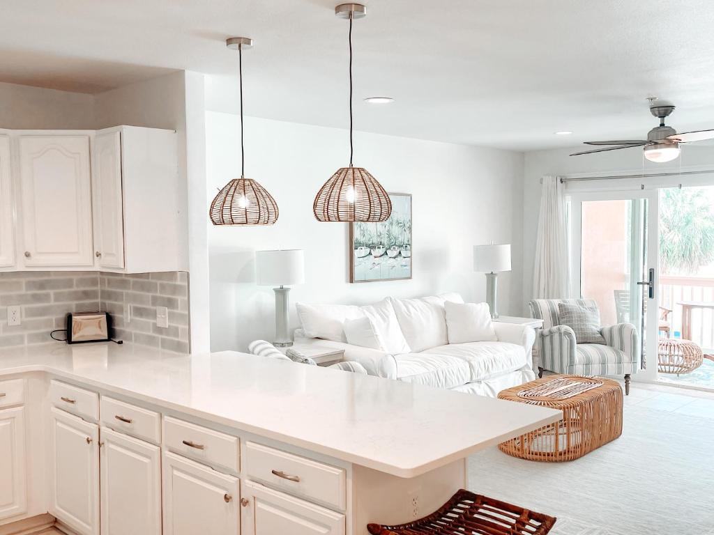 a kitchen and living room with a white counter top at Sand Buckets Unit B, Ocean View Beach Townhouse in Mexico Beach