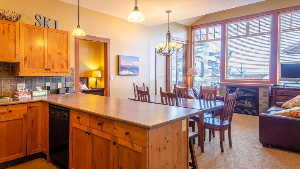 a kitchen with a table and a dining room at Settlers Crossing #11 by Bear Country in Sun Peaks