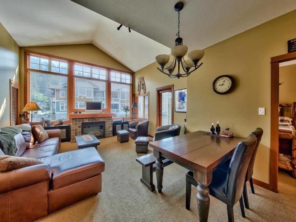 a living room with a table and a dining room at Settlers Crossing #70 by Bear Country in Sun Peaks
