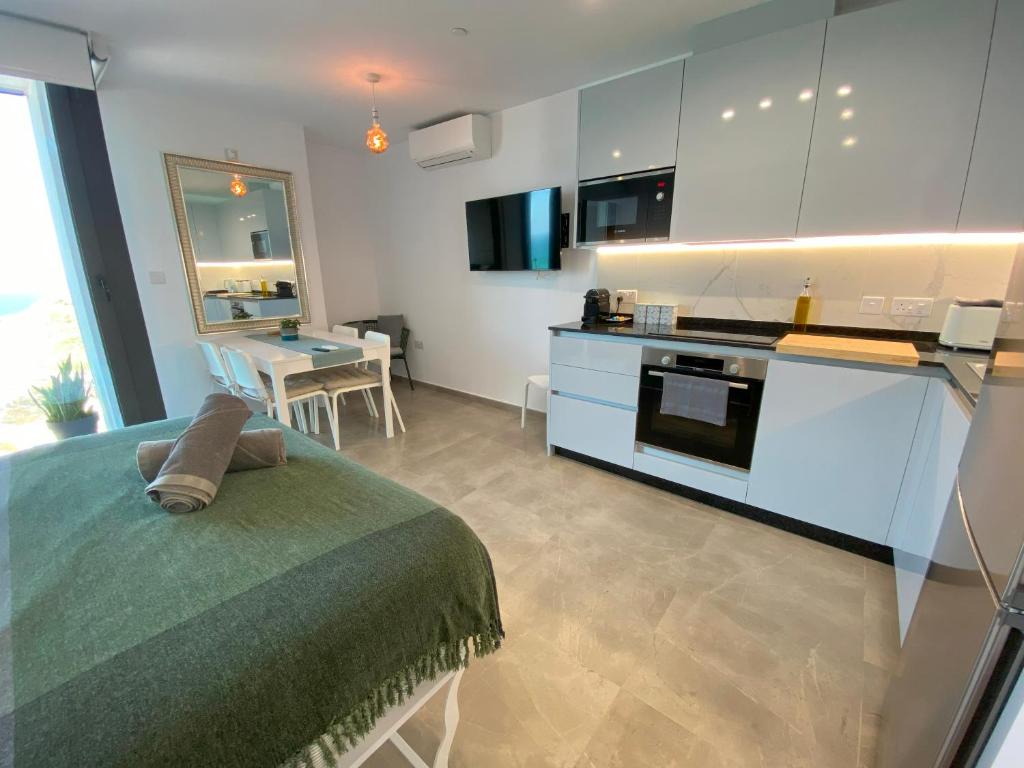 a kitchen with a bed and a table in a room at NEW Luxury Sunrise Oceanview Aparthotel in Gibraltar in Gibraltar
