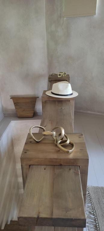 a hat sitting on top of a wooden table at ClockWise Earthy Vibe House in Apano Chora in Ano Syros