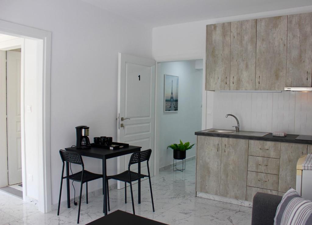 a kitchen with a table and chairs in a room at Amalia Residences in Nicosia