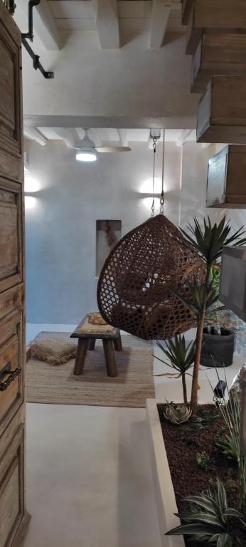 a room with a bench and a potted plant at ClockWise Earthy Vibe House in Apano Chora in Ano Syros