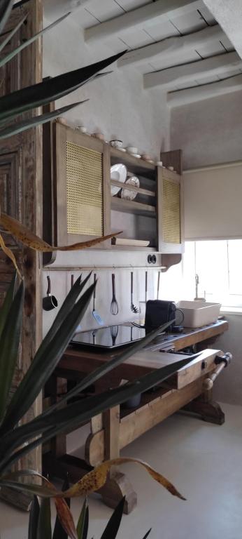 a kitchen with a table with a counter top at ClockWise Earthy Vibe House in Apano Chora in Ano Syros