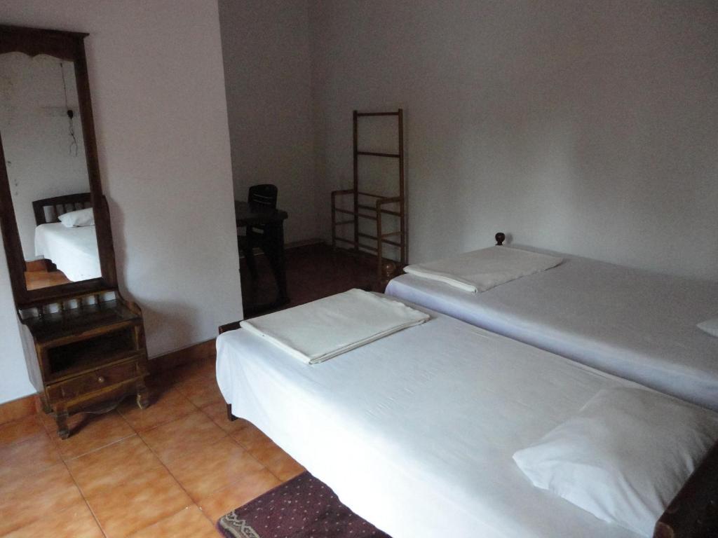 Postel nebo postele na pokoji v ubytování White Elephant Hotel