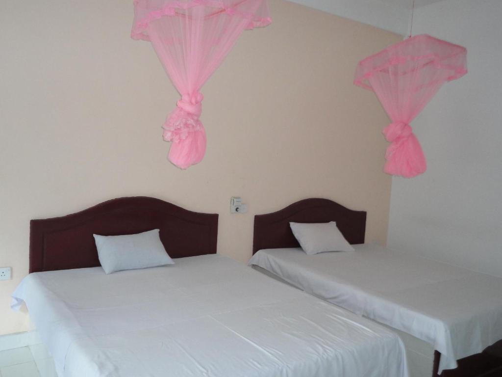 Postel nebo postele na pokoji v ubytování White Elephant Hotel