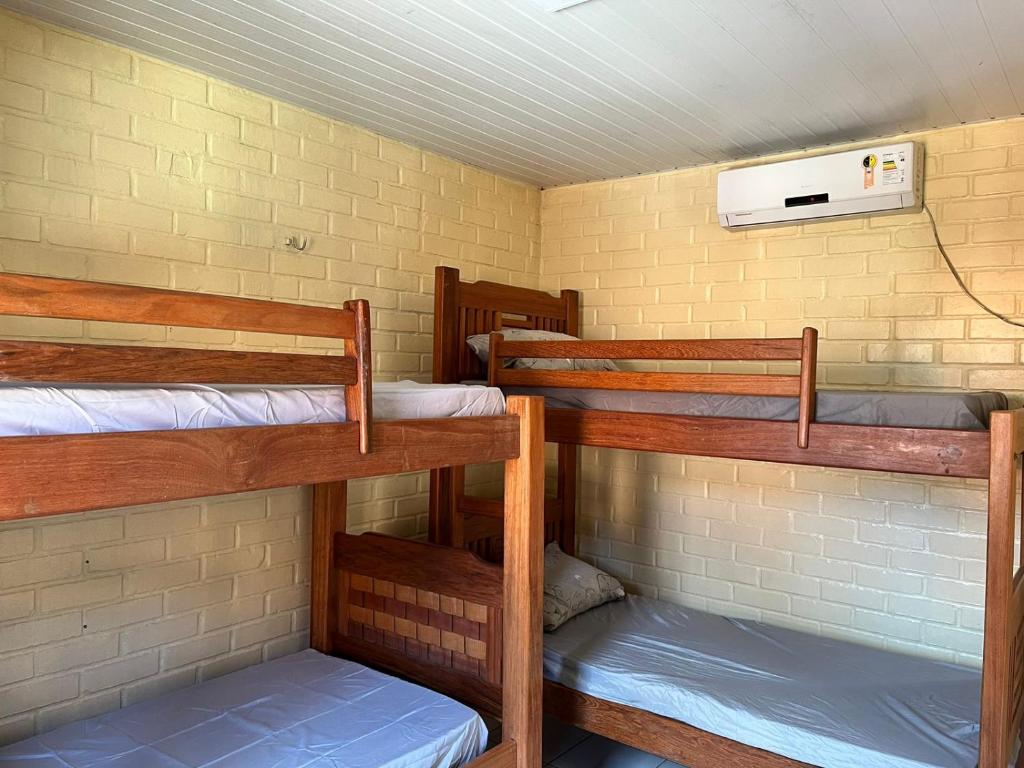 a room with three bunk beds in a building at Chalé em Barreirinhas in Barreirinhas