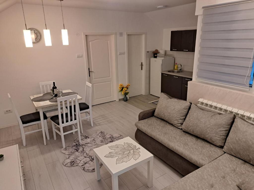 a living room with a couch and a table at Apartman MIVA in Bele Vode