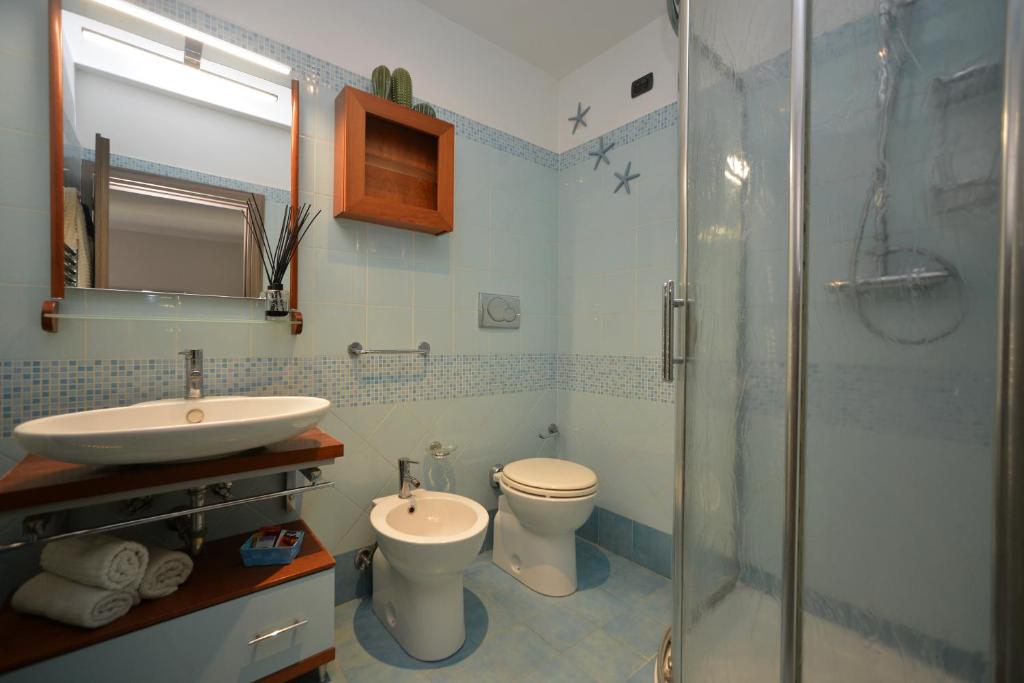 een badkamer met een wastafel, een toilet en een douche bij mentamarina in Porto Recanati