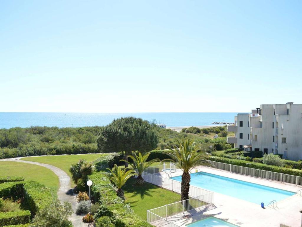 een luchtzicht op een resort met een zwembad en de oceaan bij Appartement Saint-Cyprien, 1 pièce, 4 personnes - FR-1-225D-152 in Saint Cyprien Plage