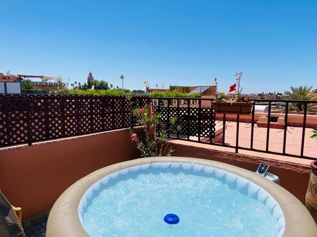 a hot tub on the roof of a building at Riad Hanya in Marrakech