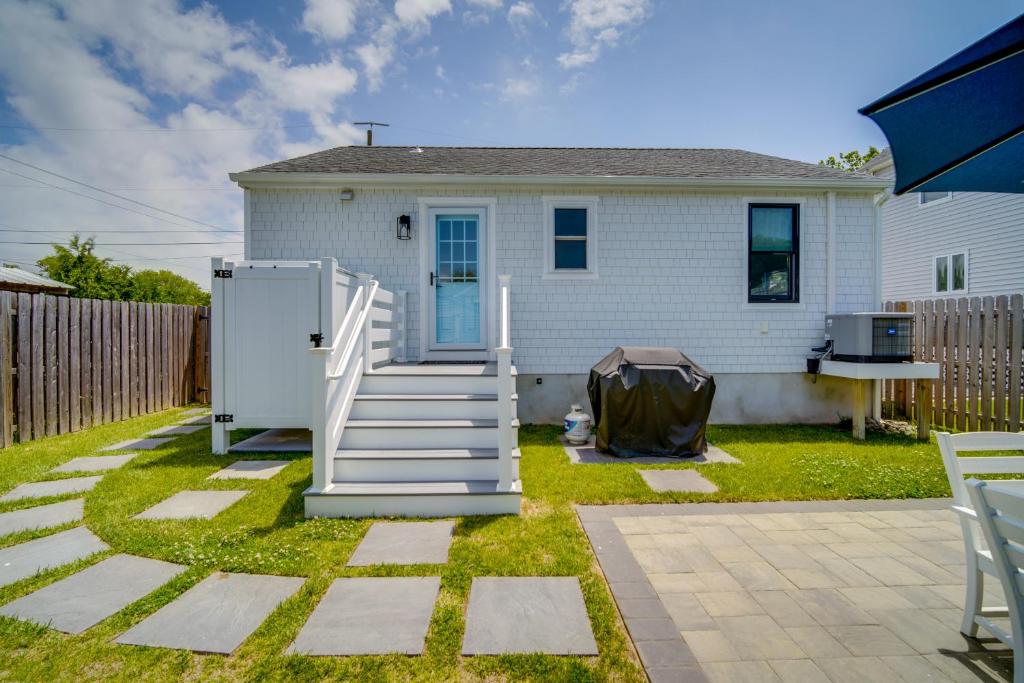 a house with a white door and stairs in a yard at Beautiful Cape May Cottage Walk to Beach and Mall! in Cape May