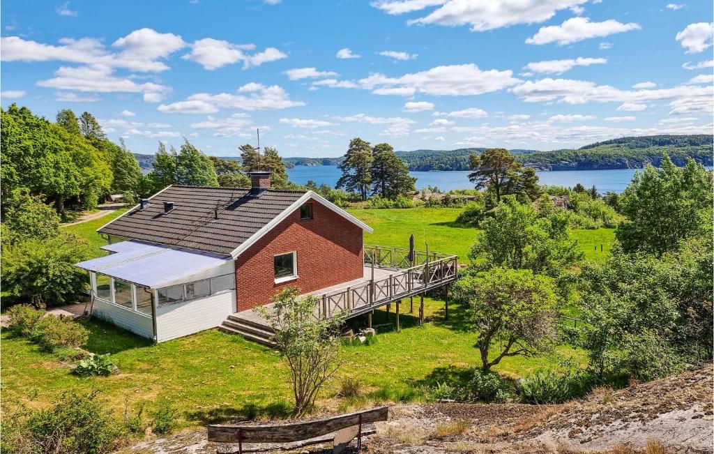an aerial view of a red and white house with a deck at 2 Bedroom Awesome Home In Brastad in Brastad